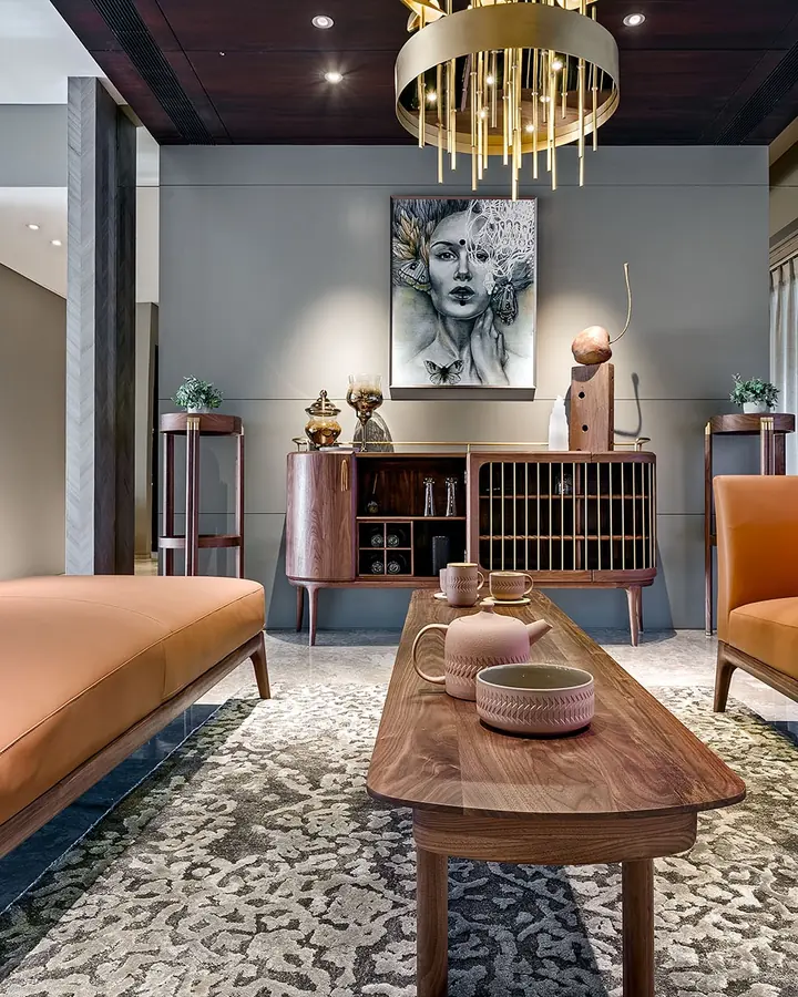 Solitaire World show flat: tan leather sofas, a walnut sideboard and a brass chandelier.