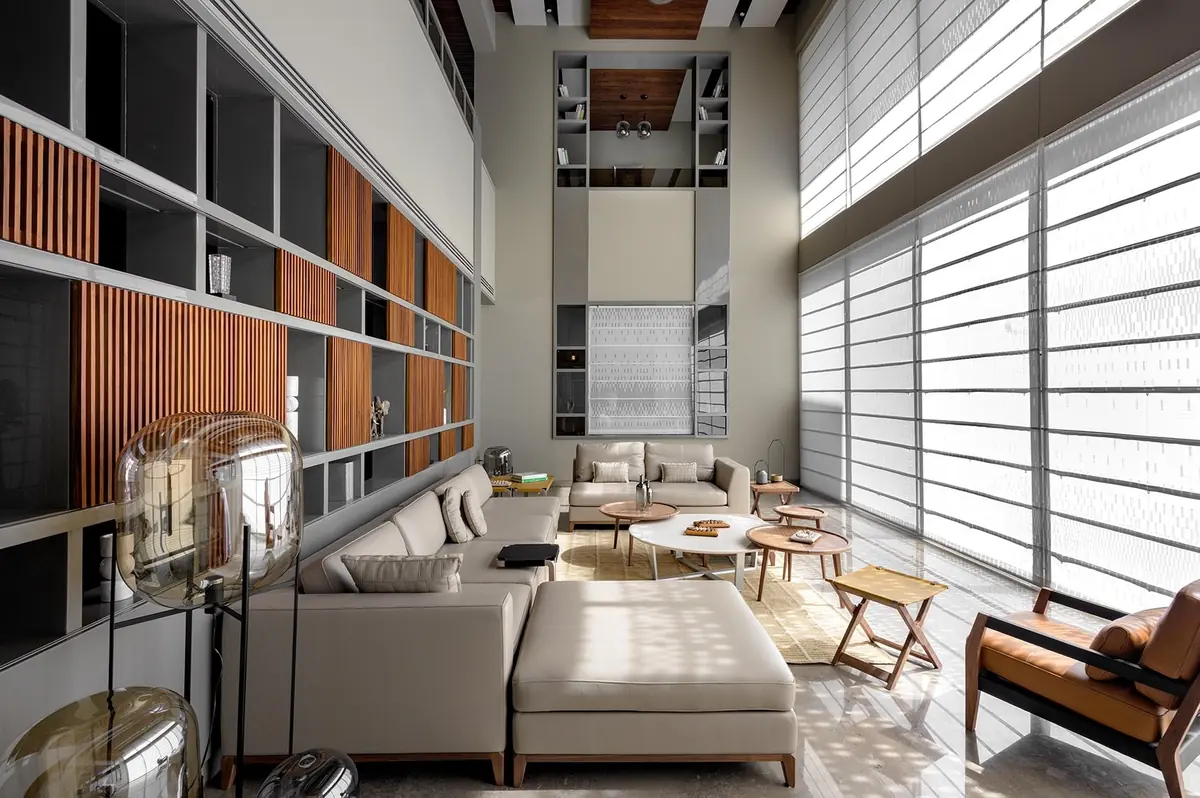 Cutting Edge House: living room: full-height timber shelving and sheer blinds.