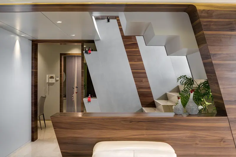 Space Edge penthouse: an angular staircase wrapped in walnut timber.